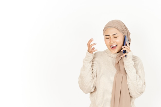 Talking on the Phone with Angry Expression of Beautiful Asian Woman Wearing Hijab Isolated On White