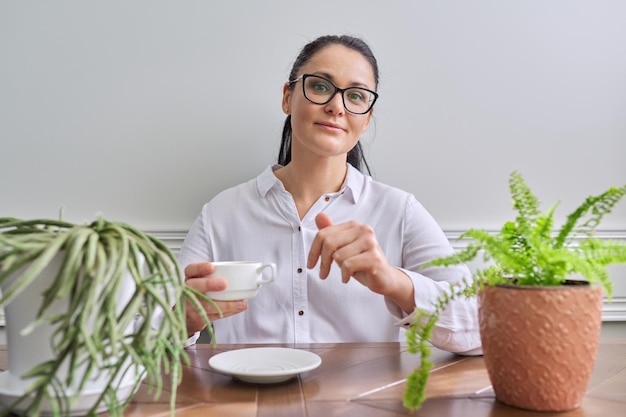 Talking positive business woman looking at camera closeup face