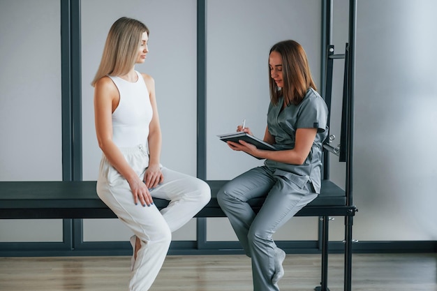 Talking with each other woman is in health center getting help
by doctor