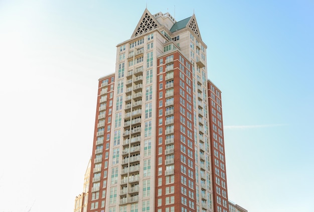 A tall building with a pointed roof and a white roof.