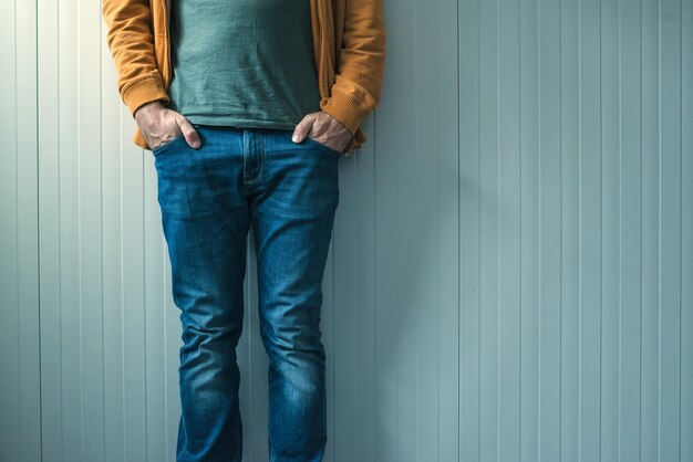 Tall casual man in jeans posing