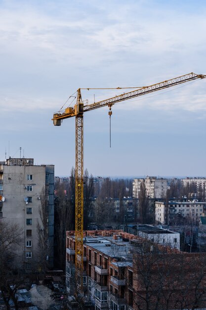 Tall construction crane at a building site