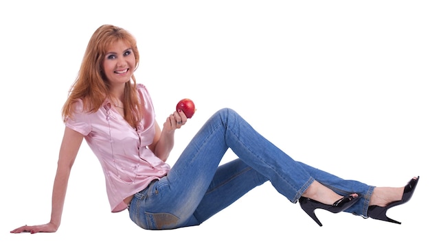 Tall mature woman in jeans sit with apple