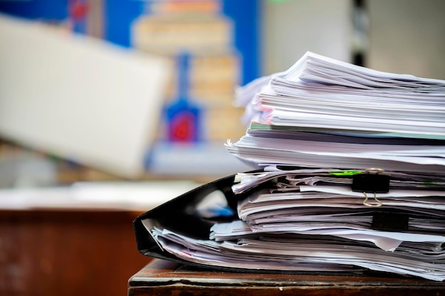 Tall papers waiting to be dealt with are placed on the desks