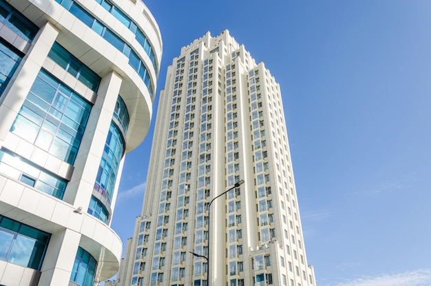 A tall white building with a blue sky behind it