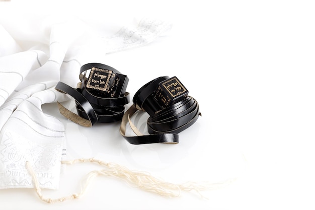 Tallit and tefillin on white background