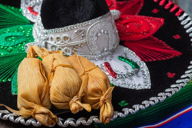 Photo tamales next to a serape and a mexican mariachi hat