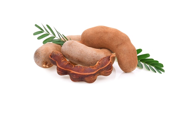 Tamarind fruits and leaves isolated on white