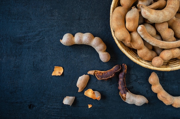 Tamarind in a wooden basket on the table