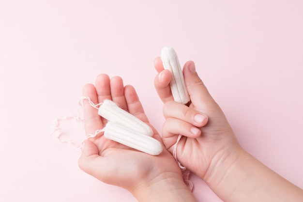 Tampons in female hands Lack of feminine hygiene products