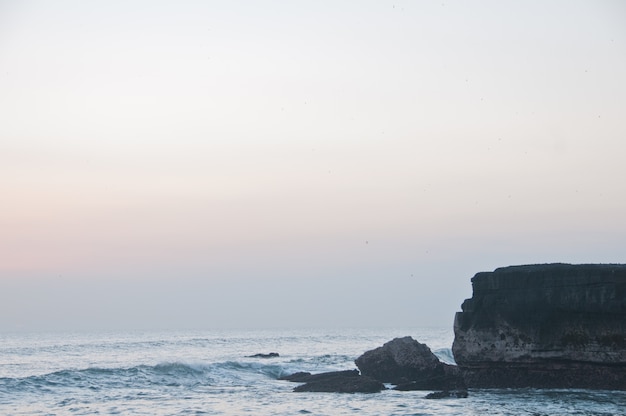 Tanah Lot beach and stone clift in Bali sea