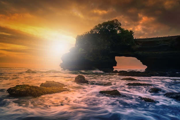 Tanah Lot Temple on sea at sunset in Bali Island