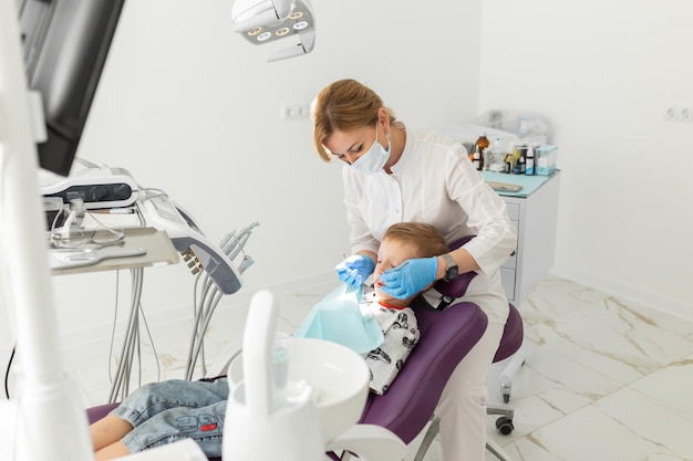 Tandarts en kindpatiënt in tandartspraktijk