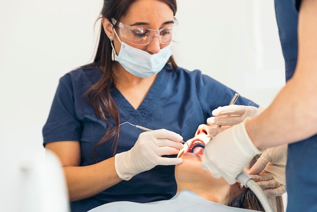 Tandartsen met een patiënt tijdens een tandheelkundige ingreep. Medisch concept.