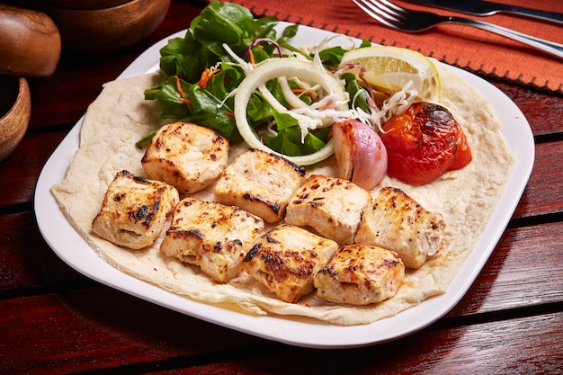 Tandoori Chicken Malai tikka boti with lemon salad and bread served in dish isolated on table side view of middle east food