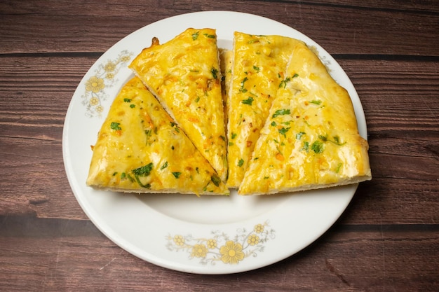 Tandoori Garlic chili nan naan nun served in dish isolated on wooden table top view indian spices food