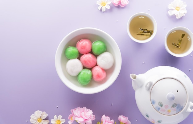 Tang Yuansweet dumplings balls a traditional cuisine for Midautumn Dongzhi winter solstice and Chinese new year on pastel background