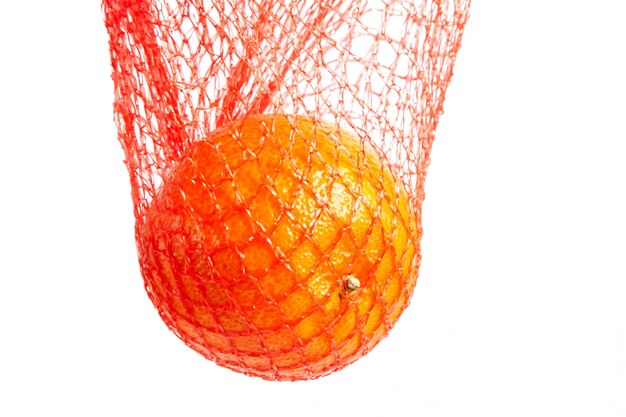 Tangerine citrus fruit in red net isolated on white background