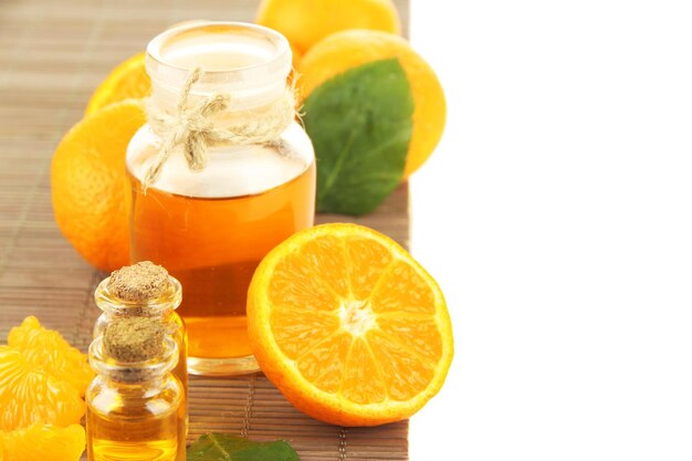 Tangerine essential oil and tangerines isolated on white