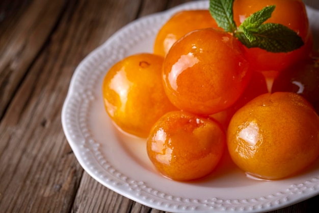 Tangerine jam in glass jar with fruit around