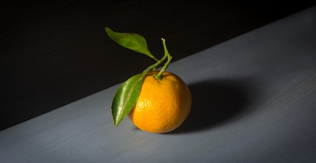 Tangerine or mandarin orange on wooden background.