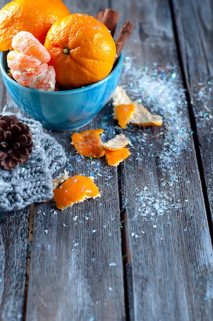 Tangerine in scarf over wooden background