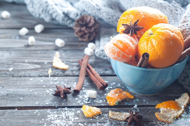 Tangerine in scarf over wooden background