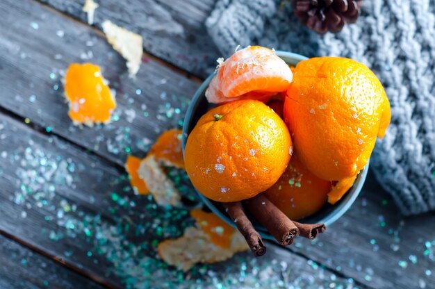 Tangerine in scarf over wooden background