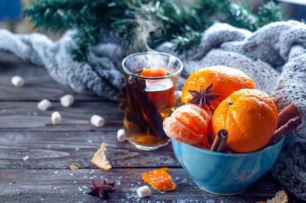 Tangerine in scarf over wooden background