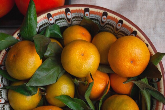 Tangerines are lying on a beautiful dish close-up.