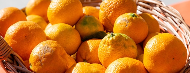 Tangerines in a basket in the bright sun