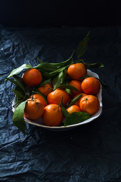 Tangerines on the black paper