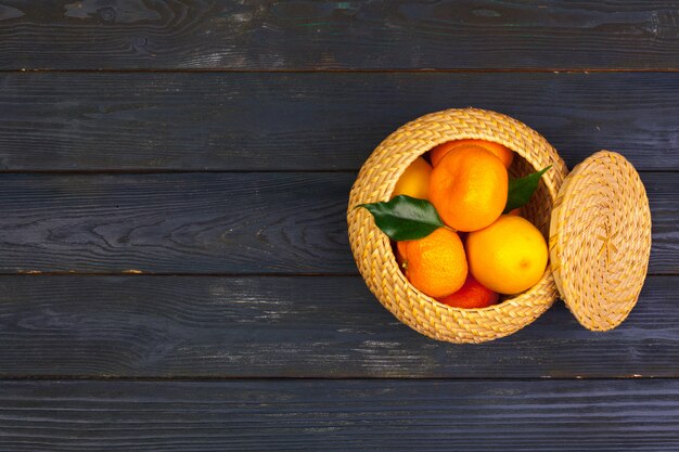 tangerines on a black wooden background