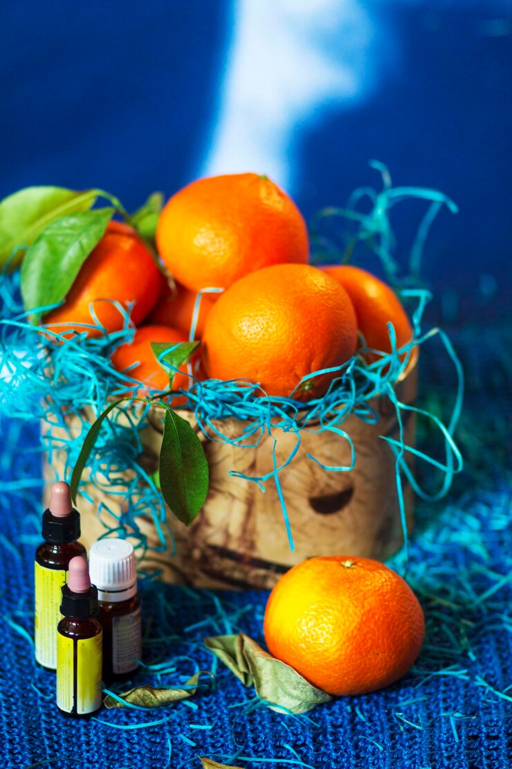 Photo tangerines in a gift box and bottles of essential oils