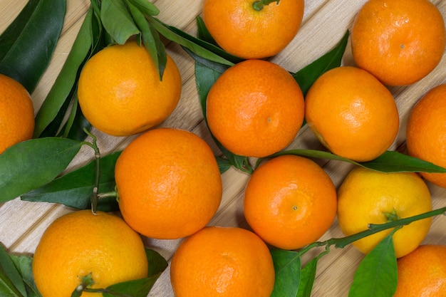 Tangerines and green leaves on the table