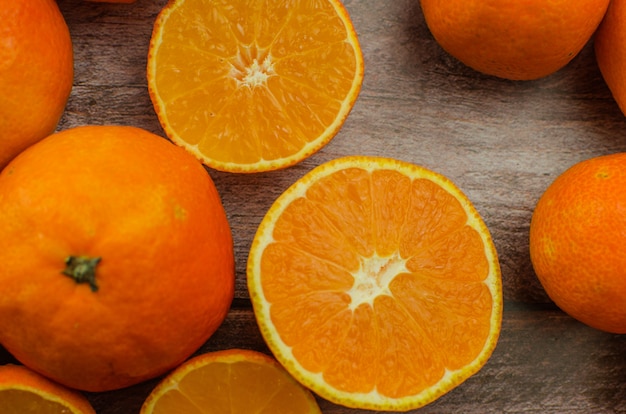 Tangerines, peeled tangerine and tangerine slices on a white wooden table. copy space