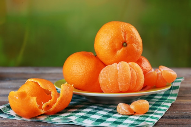 Tangerines in plate on table