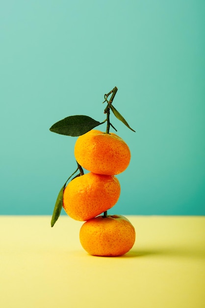 Tangerines with green leaves Colored background