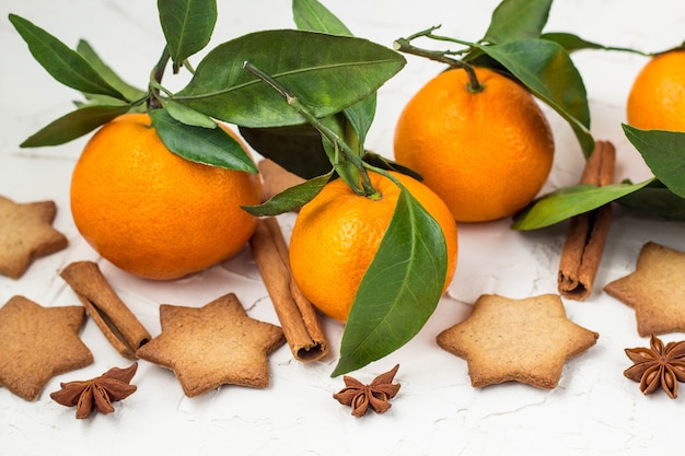 Tangerines with green leaves and cookies