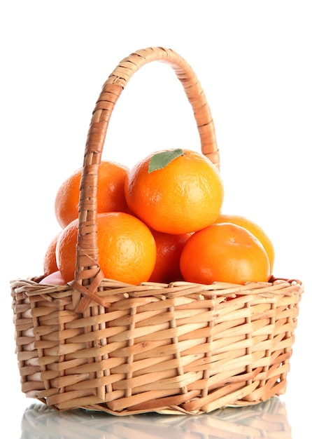 Tangerines with leaves in a beautiful basket isolated on white