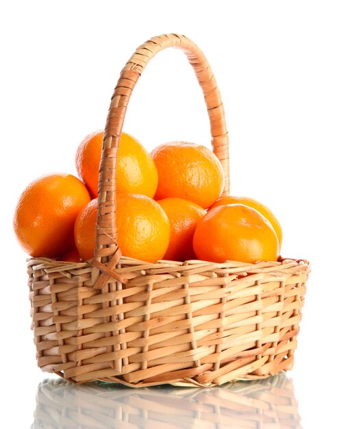 Tangerines with leaves in a beautiful basket isolated on white