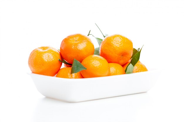 Tangerines with leaves isolated over white