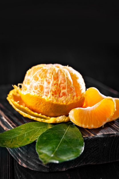 Tangerines with leaves on an old fashioned country table