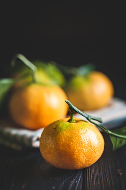 Tangerines with leaves on an old fashioned country table