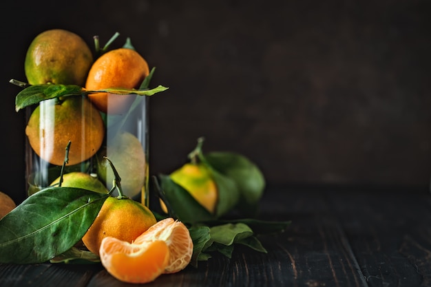Tangerines with leaves on an old fashioned country table