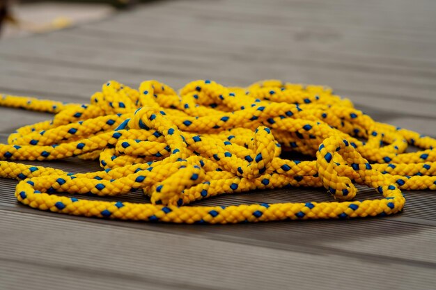 Tangle wet yellow rope on a deck