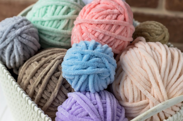 Tangles of plush yarn Basket with knitting threads Plush yarn