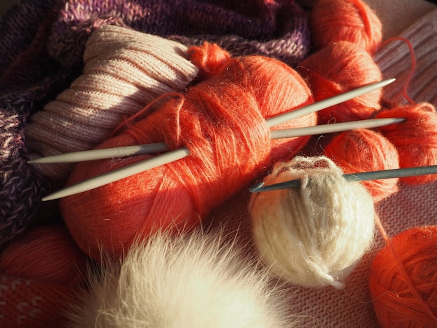 Tangles snarls balls of yarn and thread knitted clothes\
knitting needles and crochet hooks