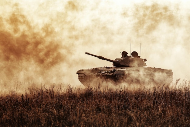 Tank advances across a dusty battlefield in a dramatic armored display at sunset