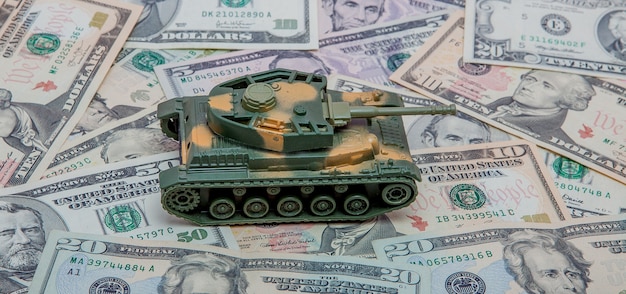 Tank against the background of dollars. Concept of war.